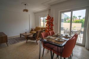 a living room with a table and chairs and a couch at HONEY SUİTEs 1 in Fethiye