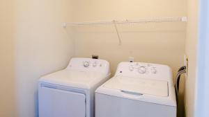 a laundry room with a washer and dryer at Watermen's Cabana 2B - 2-Bed, 1-Bath - Walk To BEACH Access & PET Friendly! in Waves