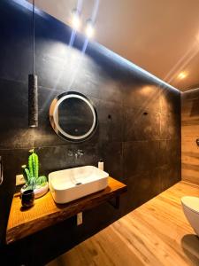 a bathroom with a sink and a mirror at Luna Mare Boutique Seaside in Borsh