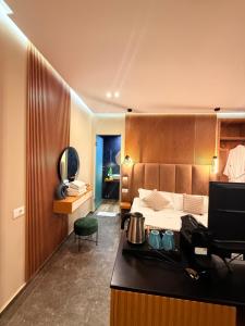 a bedroom with a bed and a desk with a computer at Luna Mare Boutique Seaside in Borsh