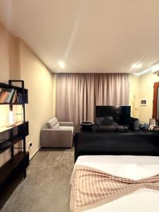 a bedroom with a bed and a living room with a couch at Luna Mare Boutique Seaside in Borsh