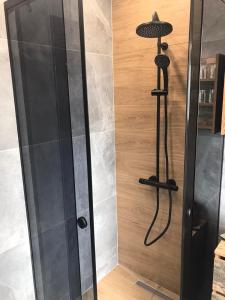 a shower with a glass door in a bathroom at Апартаменти ''Димови'' in Lozenets +36 photos