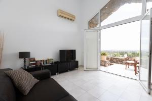 a living room with a couch and a sliding glass door at Los Miradores Two Bedroom Apartment La Manga Club RPM387 in Atamaría