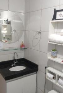a bathroom with a sink and a mirror at kitnet encantador no centro de Campina Grande- PB - apt 102 in Campina Grande