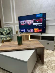 a living room with a large flat screen tv at Bel appartement moderne à Agadir in Dcheira El Jihadia