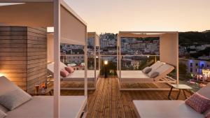 a balcony with two chairs and a view of a city at Hotel Indigo Albufeira by IHG in Albufeira