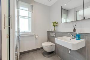 Un baño blanco con inodoro y lavabo. en 2 BD Soho Luxury Living-High Ceilings Huge Terrace, en Londres 26 fotos más