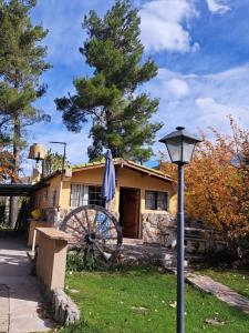 a house with a windmill in front of it at Anto'n casa de montaña in Potrerillos