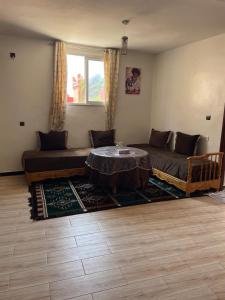 a living room with a couch and a table at Warm apartment with sea view in Rbat +10 photos