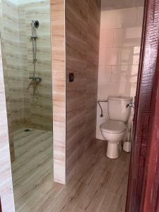 a bathroom with a toilet and a shower at Warm apartment with sea view in Rbat