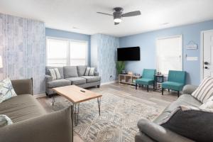 a living room with couches and a flat screen tv at ONE More Happy Day 3BR-3BA Beach House w-HotTub, Sleeps 11 in Myrtle Beach
