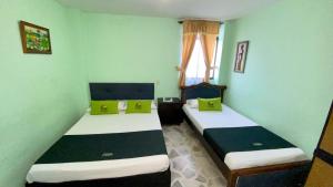 Postel nebo postele na pokoji v ubytování Hotel El Bosque