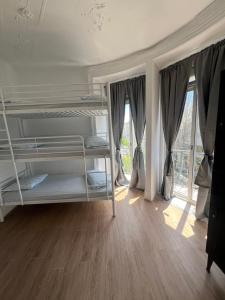 a bedroom with two bunk beds and a window at Bagetti hostel only for girls in Lisbon