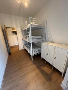 a small room with a bunk bed in a room at Bagetti hostel only for girls in Lisbon