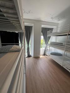 a bedroom with two bunk beds with wooden floors at Bagetti hostel only for girls in Lisbon