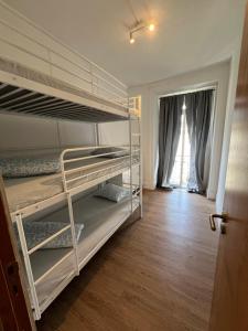 a room with two bunk beds and a hallway at Bagetti hostel only for girls in Lisbon