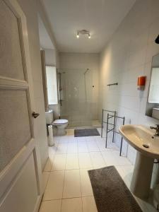 a bathroom with a toilet and a sink at Bagetti hostel only for girls in Lisbon