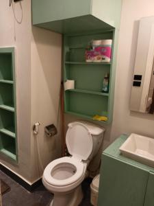 a bathroom with a white toilet and a sink at Palma House in Hurghada