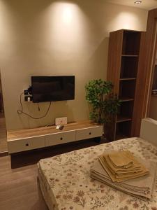 a living room with a tv and a bed at Palma House in Hurghada