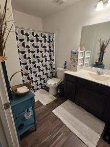 a bathroom with a sink and a toilet and a mirror at Imani in Manor