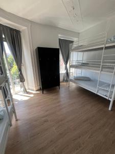 a room with two bunk beds and a wooden floor at Bagetti hostel only for girls in Lisbon