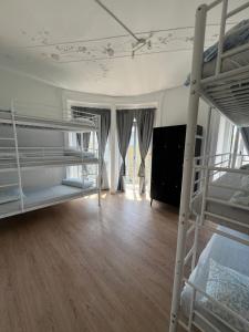 a bedroom with two bunk beds and a living room at Bagetti hostel only for girls in Lisbon