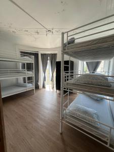 two bunk beds in a room with wooden floors at Bagetti hostel only for girls in Lisbon