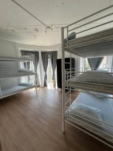 two bunk beds in a room with a wooden floor at Bagetti hostel only for girls in Lisbon +9 photos