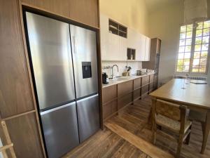 a kitchen with a large stainless steel refrigerator at Résidence 157-soulac Sur Mer - 157 - Maison de Charme de Style Basque avec Piscine Privée MAE-7391 in Soulac-sur-Mer +13 photos