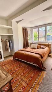 a bedroom with a large bed and a rug at Résidence 157-soulac Sur Mer - 157 - Maison de Charme de Style Basque avec Piscine Privée MAE-7391 in Soulac-sur-Mer