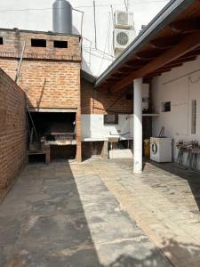 an outdoor patio with a brick wall and a building at Casa dos dormitorios in Bella Vista