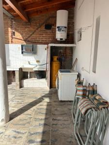 a room with a kitchen with a sink and chairs at Casa dos dormitorios in Bella Vista
