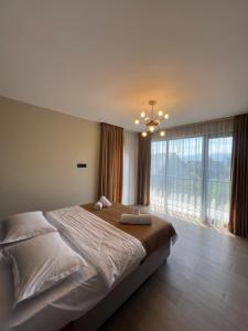a bedroom with a large bed and a large window at Villa Feel Georgia in Batumi +34 photos