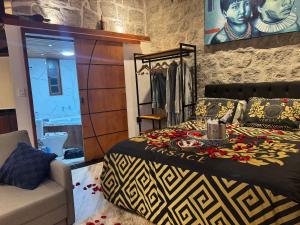 a bedroom with a king sized bed and a couch at Minas Em Marambaia in Rio de Janeiro
