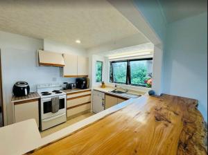 a kitchen with a wooden counter top in a room at Neptune Lodge in Whangarei Heads