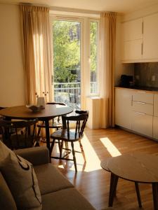 a living room with a table and a kitchen at Blue House Odda in Odda