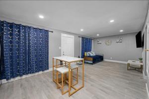 a living room with a table and a couch at Charming Getaway in Houston Heights in Houston
