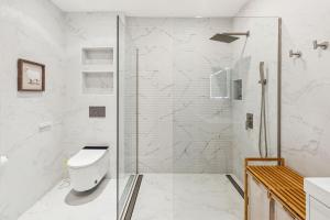 a white bathroom with a shower and a toilet at 24 Stay - Philadelphia Rittenhouse in Philadelphia +40 photos