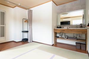 a living room with a mirror on the wall at スプリングヒルズ高田屋 in Hakodate +46 photos