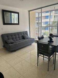 a living room with a couch and a table at PUERTO AZUL CLUB House in Ricaurte