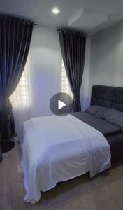 a bedroom with a white bed and a couch at Luxury 4 Bedroom Duplex at WTC Estate in Enugu