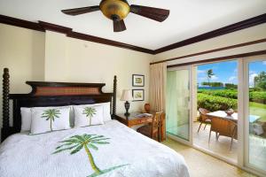 a bedroom with a bed and a sliding glass door at Waipouli Beach Resort Exquisite Ocean Front Condo in Oceanfront H Building Sleeps 8 AC Pool in Kapaa
