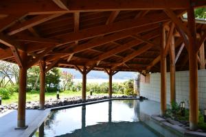 an outdoor pool with a wooden pergola at The Prince Hakone Lake Ashinoko in Hakone