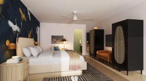 a bedroom with a large bed and a chair at The Milo in Santa Barbara
