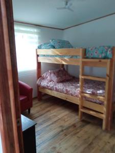 a bedroom with two bunk beds and a window at Hualqui Cabaña Santa Galoriza , Sector La Calle in El Cerrillo