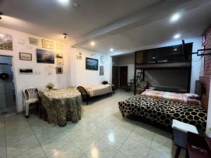 a room with a bed and a table in a room at Ugarte Street in Trujillo