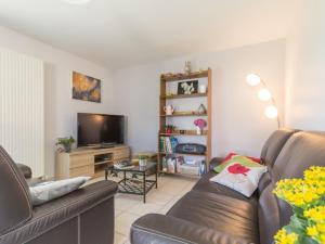 a living room with a couch and a television at Charmante maison rénovée à 300m de la Loire avec jardin, terrasse, WiFi et équipements bébé - FR-1-306-815 in Saint-Julien-de-Concelles