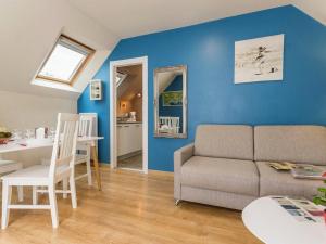 a living room with a couch and a table at Gîte calme près de plages, au cœur de Batz-sur-Mer, terrasse sud, wifi, et équipements bébé - FR-1-306-840 in Batz-sur-Mer