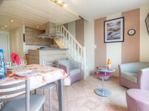 a kitchen and dining room with a table and chairs at Appartement familial avec parking, balcon vue mer, proche plages - FR-1-306-959 in La Turballe