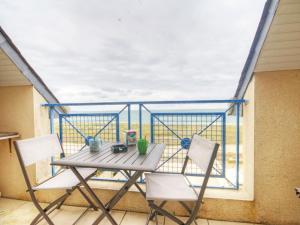 a table and two chairs on a balcony at Appartement familial avec parking, balcon vue mer, proche plages - FR-1-306-959 in La Turballe